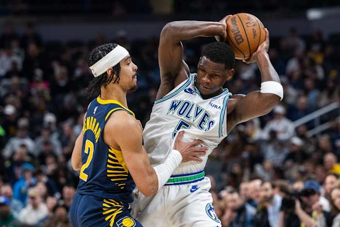 Mar 7, 2024; Indianapolis, Indiana, USA; Minnesota Timberwolves guard Anthony Edwards (5) holds the ball while Indiana Pacers guard Andrew Nembhard (2) defends during the first half at Gainbridge Fieldhouse.